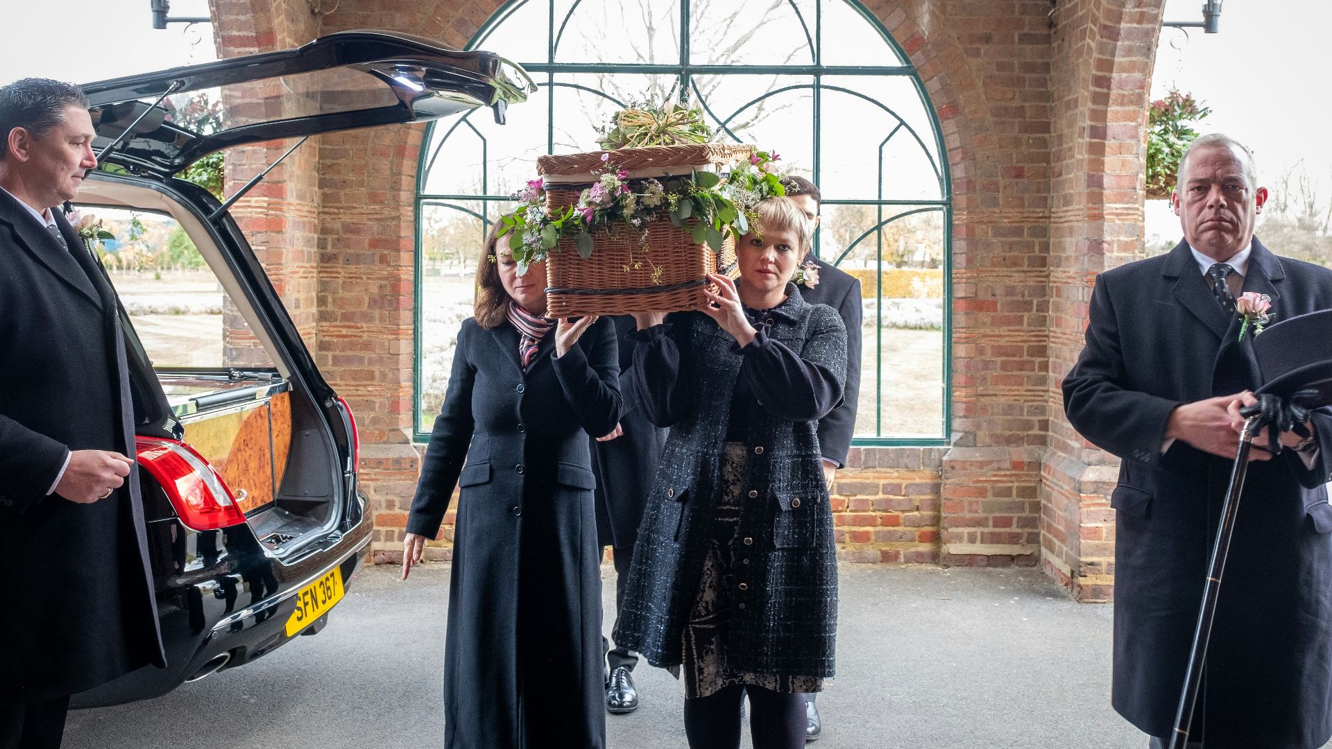 a group of people standing next to a car