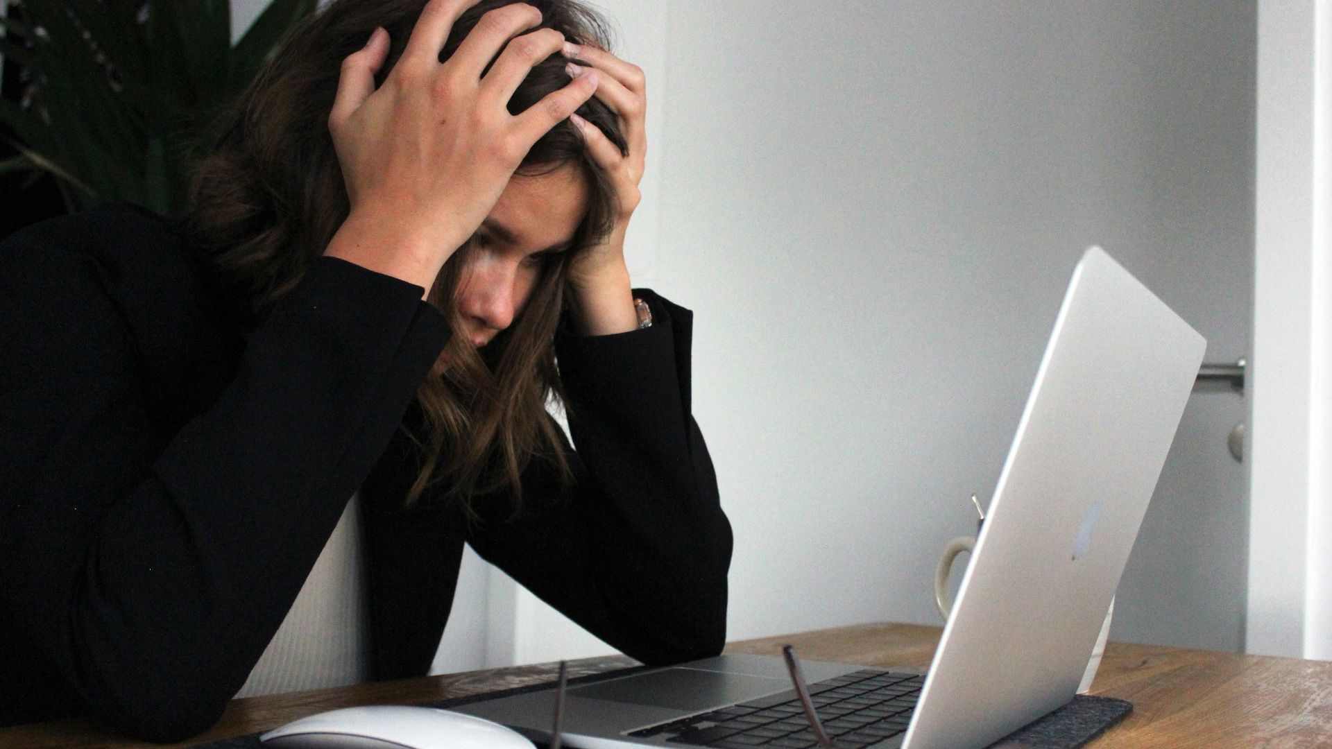 a woman sitting in front of a laptop computer