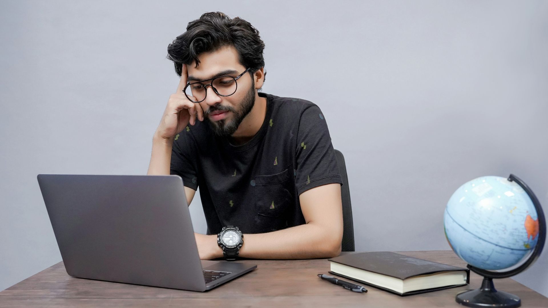 a man sitting in front of a laptop computer