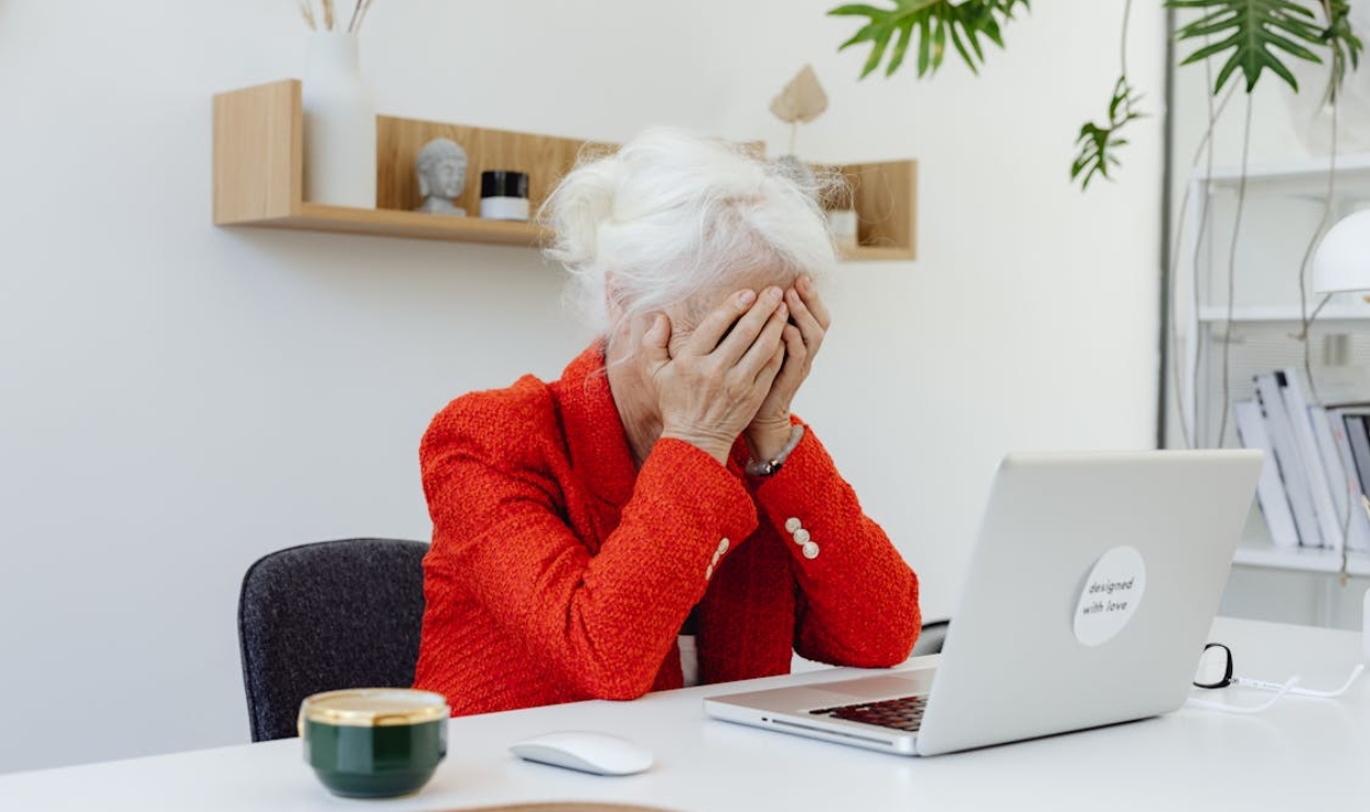 a-person-in-red-jacket-sitting-in-front-of-a-laptop-with-hands-on-face-8531094/ 