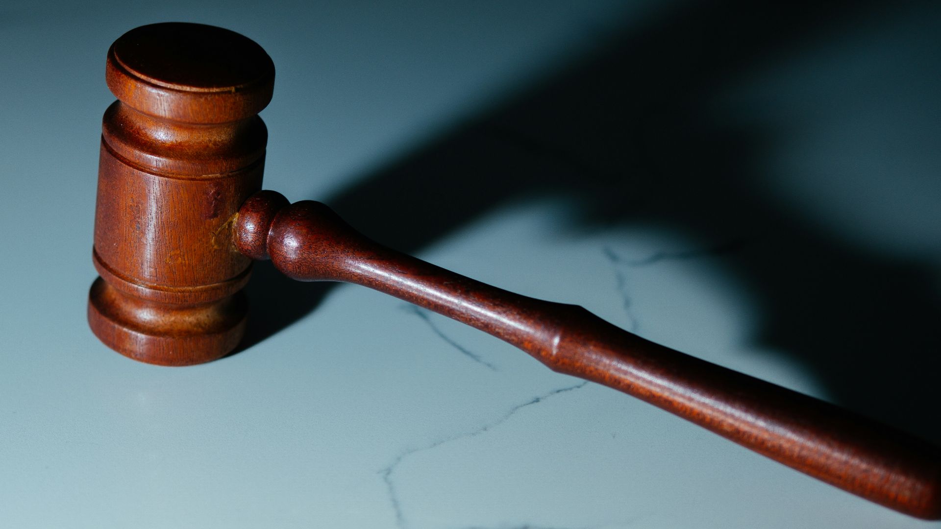 a wooden judge's hammer sitting on top of a table