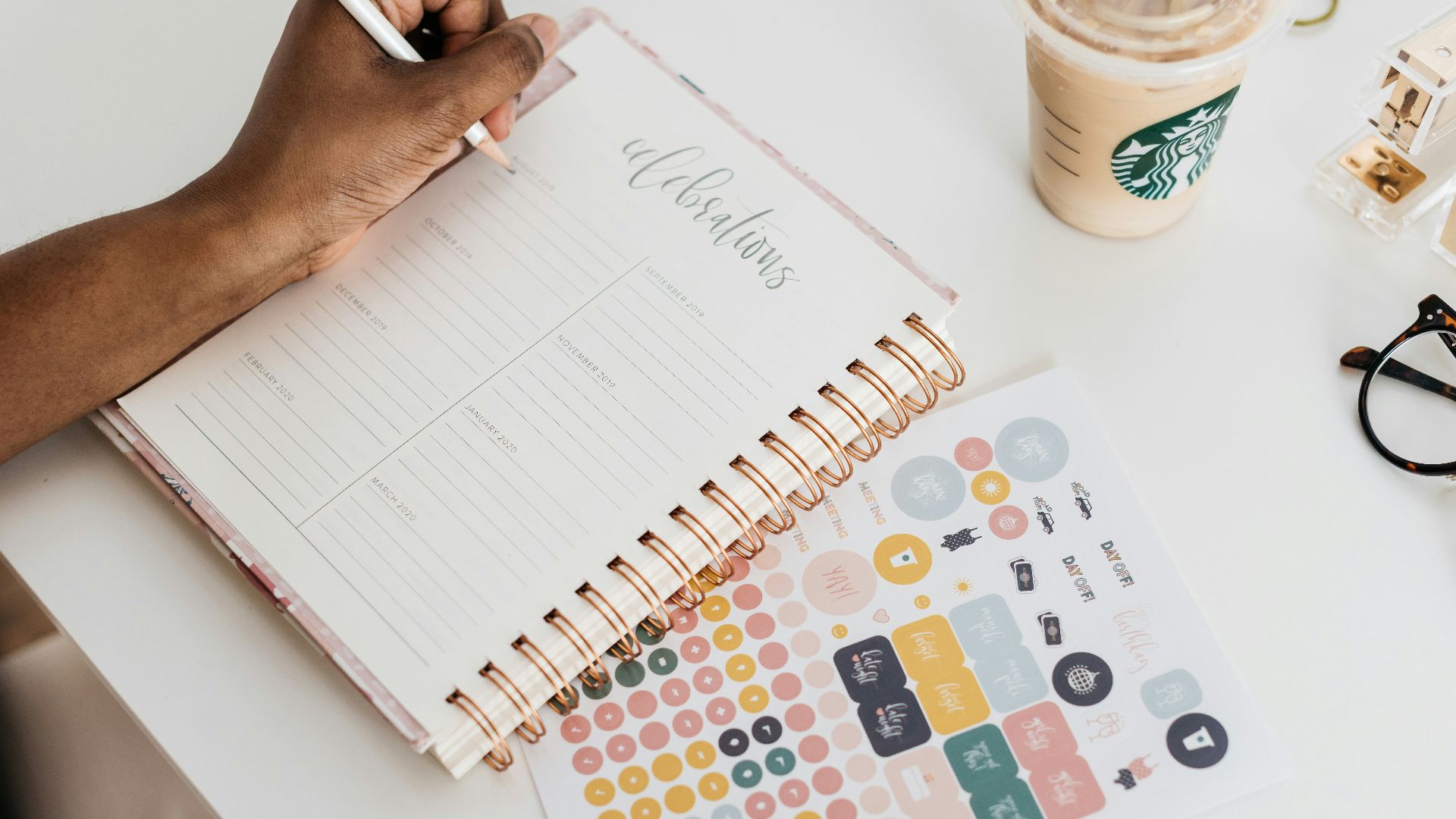 person writing at the tale