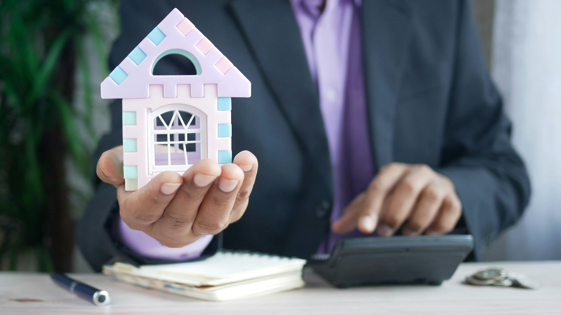 man in purple suit jacket using laptop computer