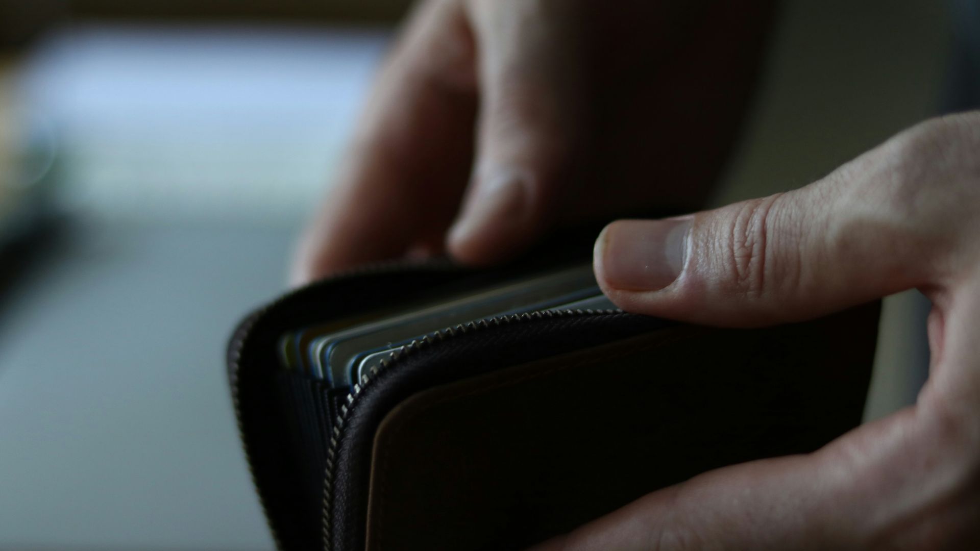 a person holding a wallet in their hand