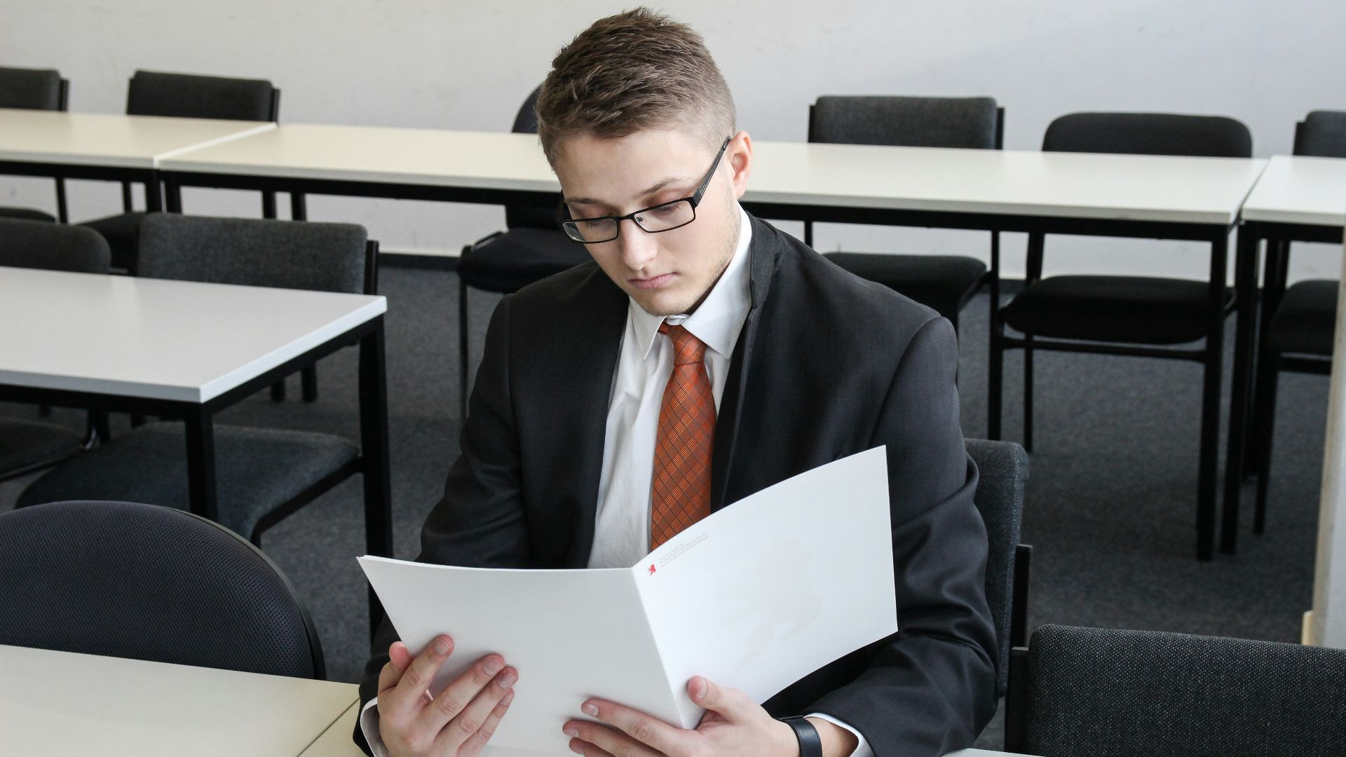 man holding folder in empty room