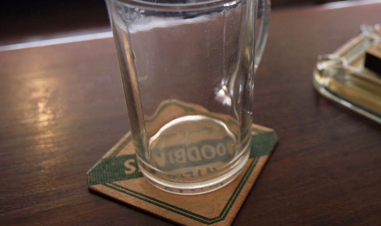 Period artifacts in bar of the Valiant Soldier Pub on May 16, 2011 in Buckfastleigh, Devon, England. The time warp pub was left unchanged from when it closed in 1965 until reopened as museum nearly 30 years later in 1998. During World War II, The Valiant Soldier was a regular haunt for American GIs based on the outskirts of the village of Buckfastleigh. After the last pint was pulled in 1965, beer glasses remained unwashed, old currency was left in the till, a darts match was left unfinished and unopened bottles of wine and beer were stashed behind the bar whilst the last landlady continued to live upstairs until she moved to a nursing home in 1997. 
