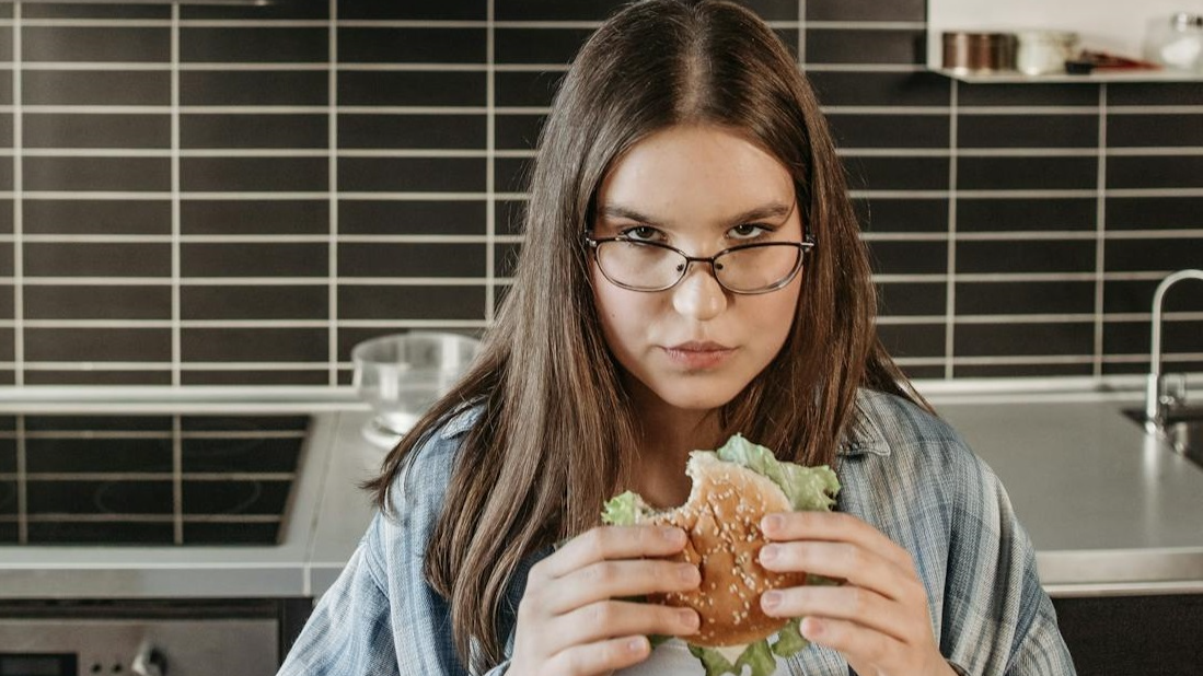 Woman Eating A Delicious Sandwich
