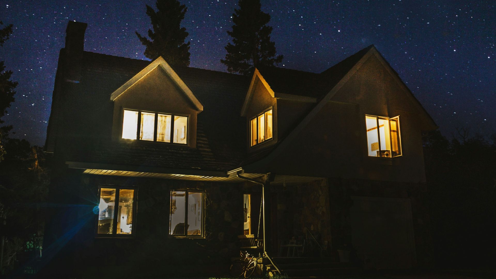 lighted 2-storey house near trees