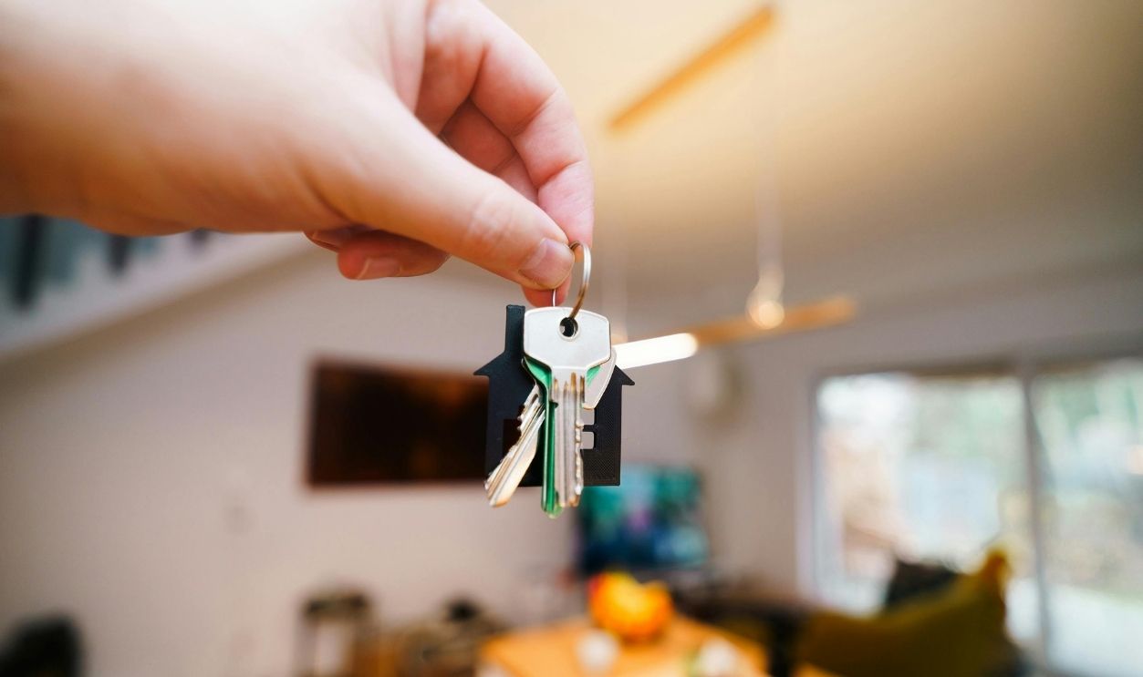 Hand Holding Keys in Modern Home Interior
