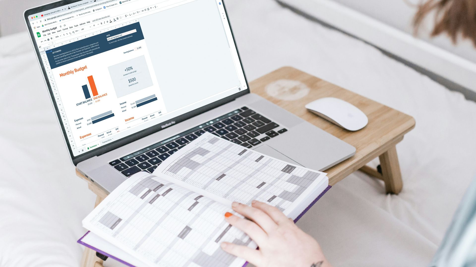 a person sitting on a bed with a laptop