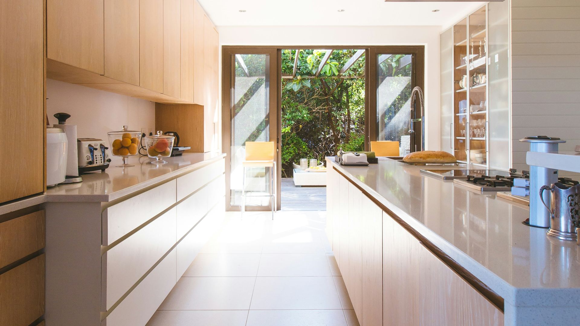 white wooden kitchen island and cupboard cabinets near glass panel door