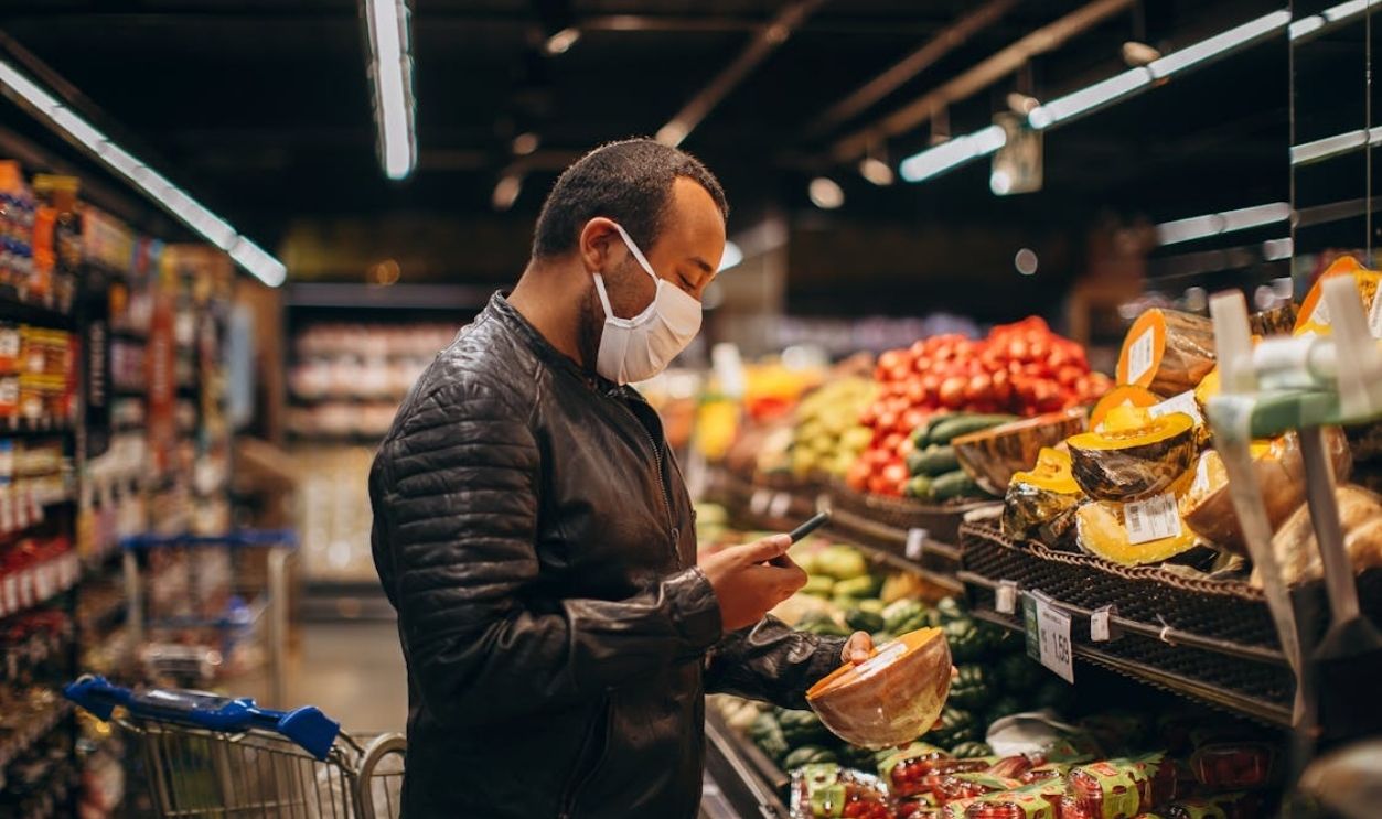 A man wearing a face mask in a grocery store