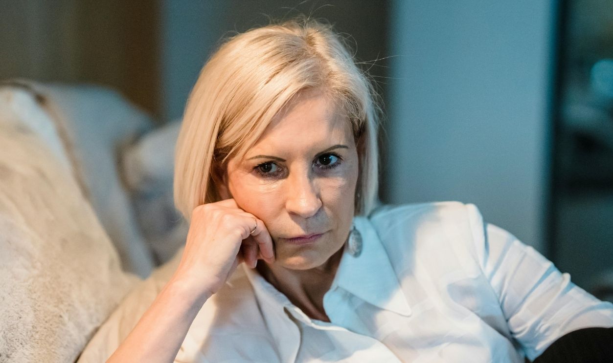 An Elderly Woman Wearing a Button Up Shirt