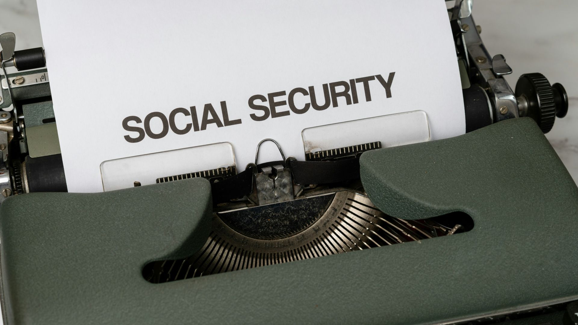 a close up of a typewriter with a paper that says social security