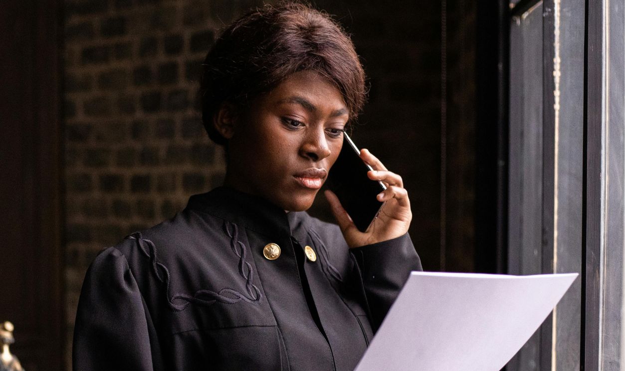 A Judge Reading a Document while Having a Phone Call