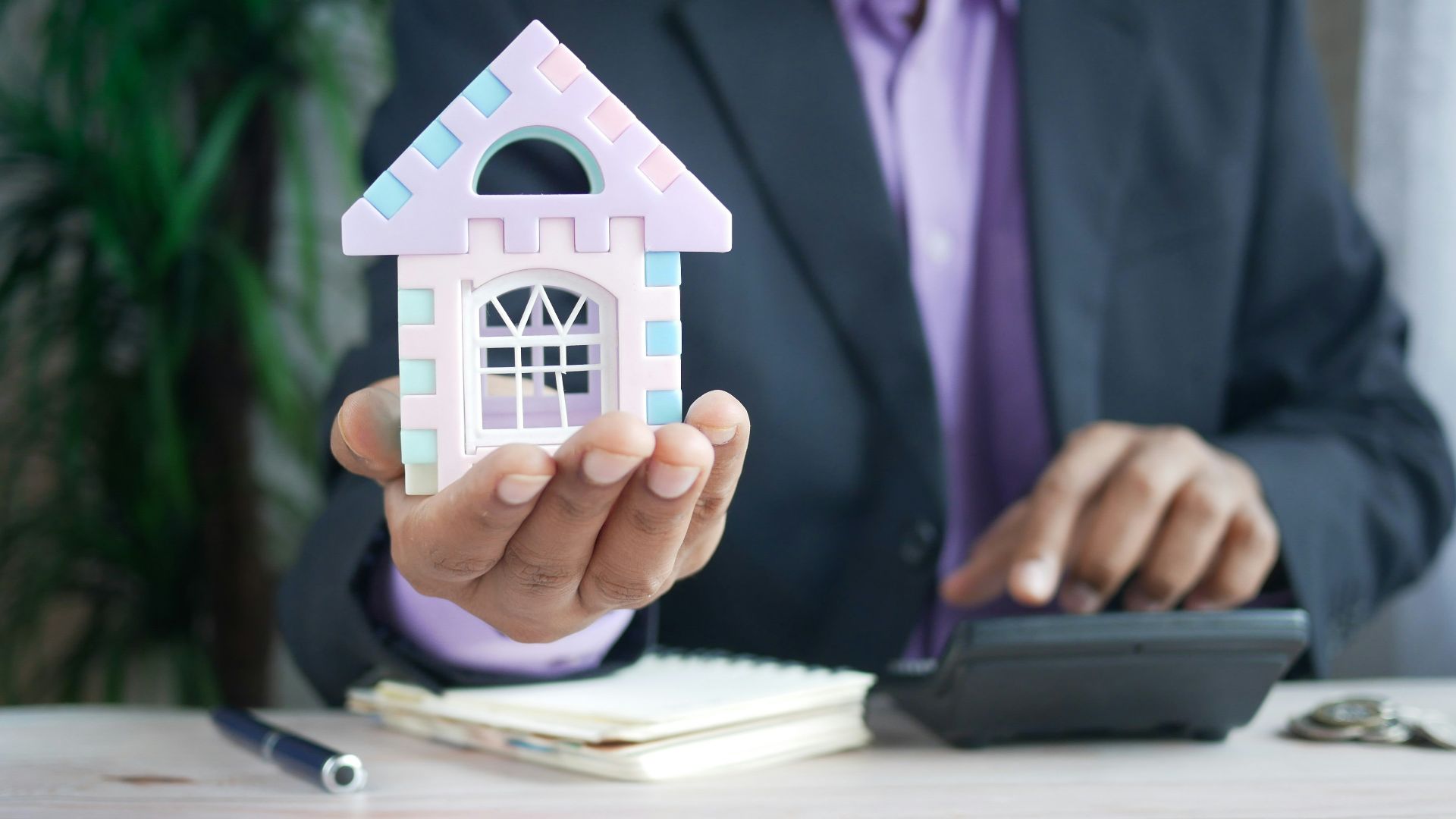 man in purple suit jacket using laptop computer