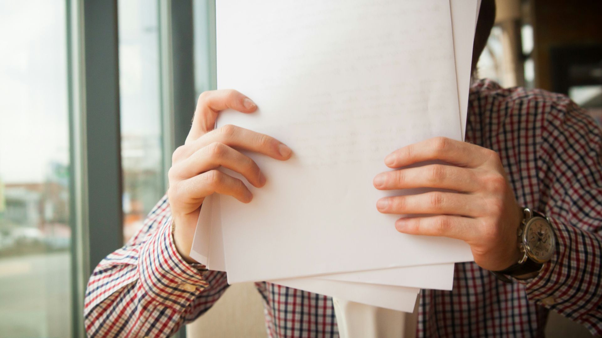 person holding white printer paper