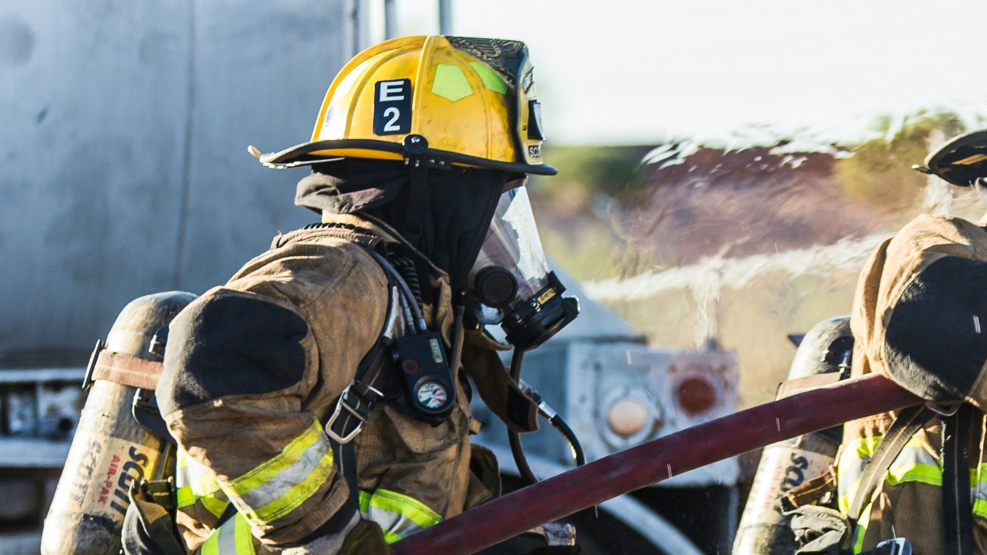 three fireman preventing fire during daytime