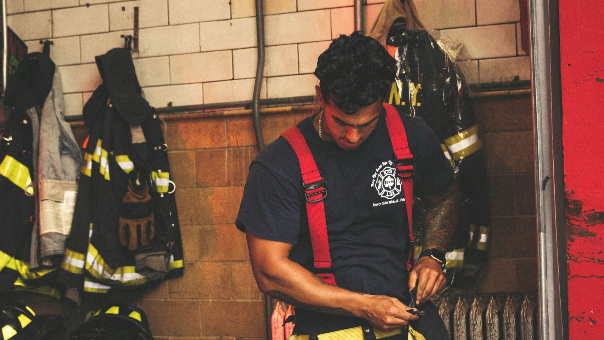 man wearing harness near black jackets
