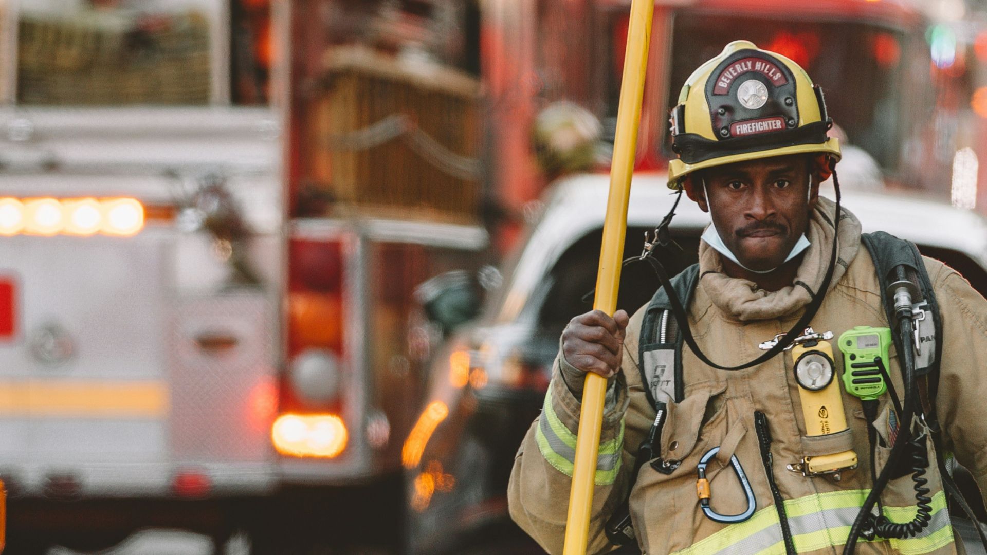 man in green and brown camouflage uniform standing near red bus during daytime