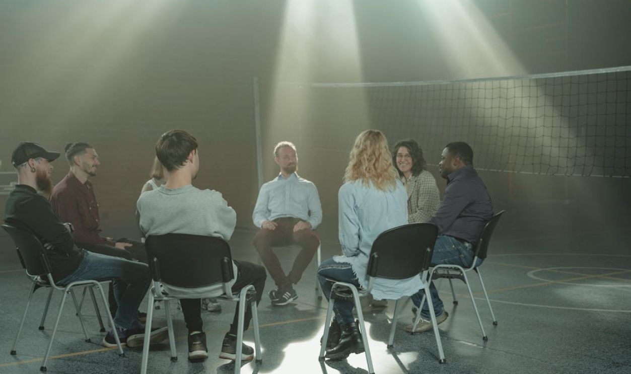 People Sitting on Chairs Inside Room