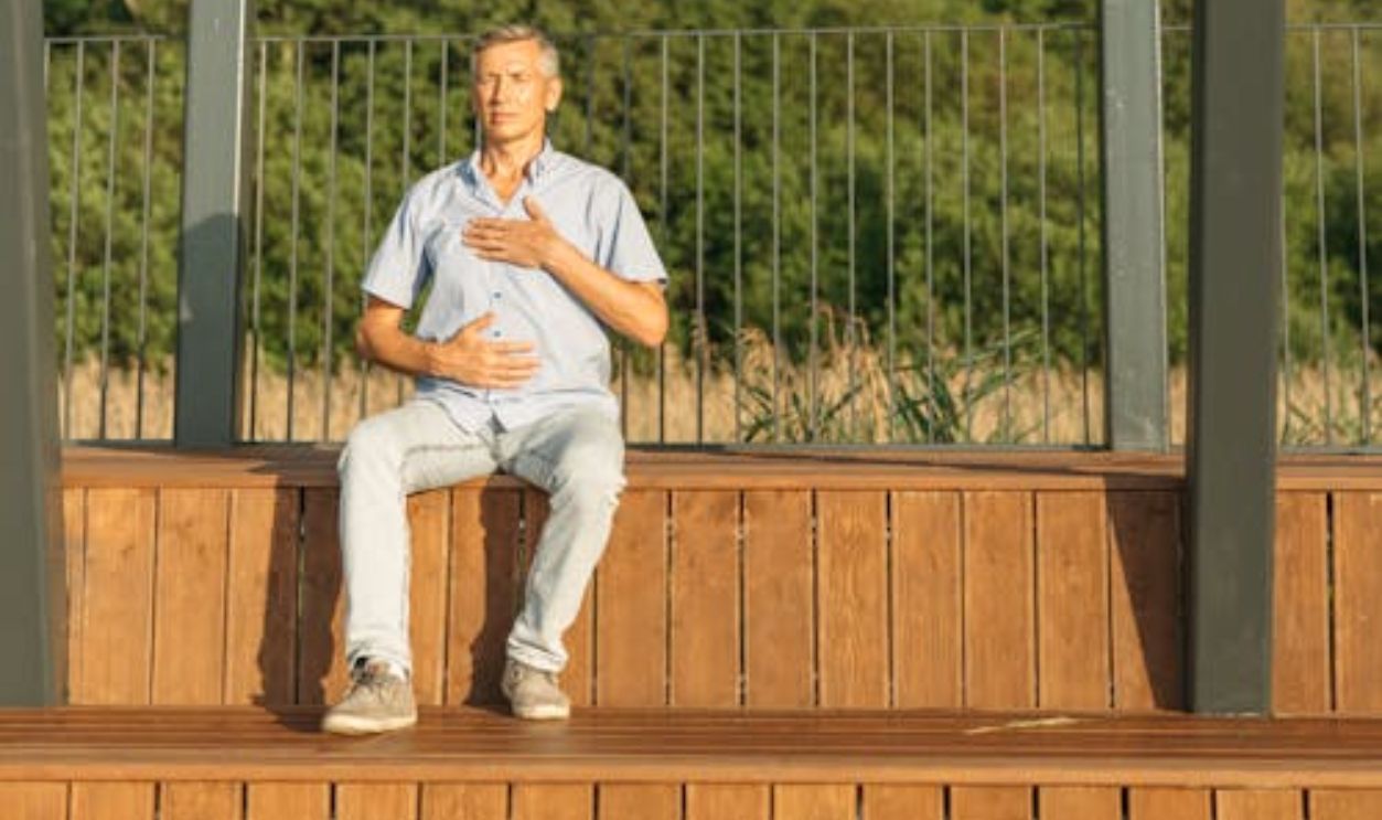 Middle-aged Man sitting on Bleachers
