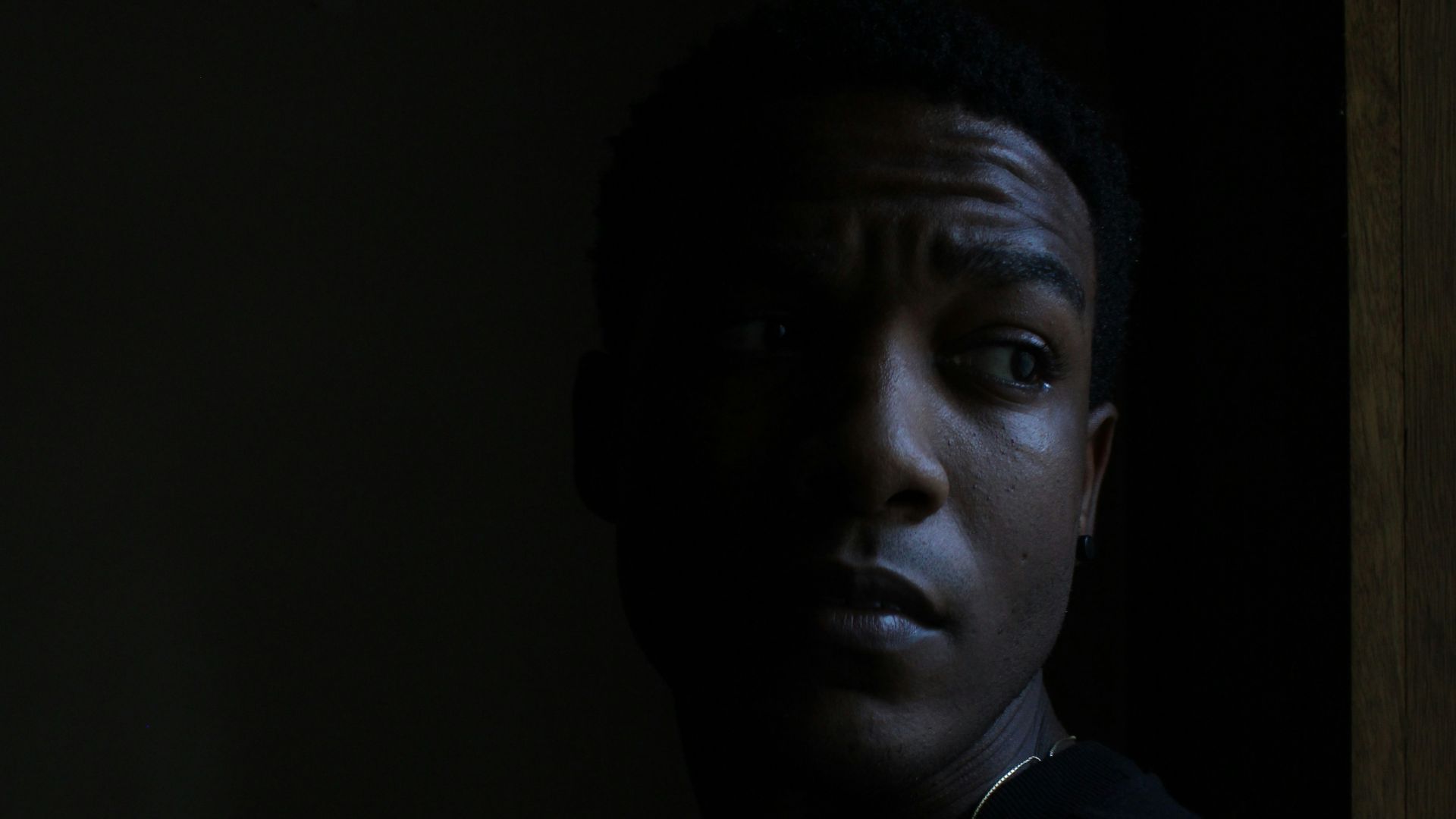 A man standing in a dark room in the dark