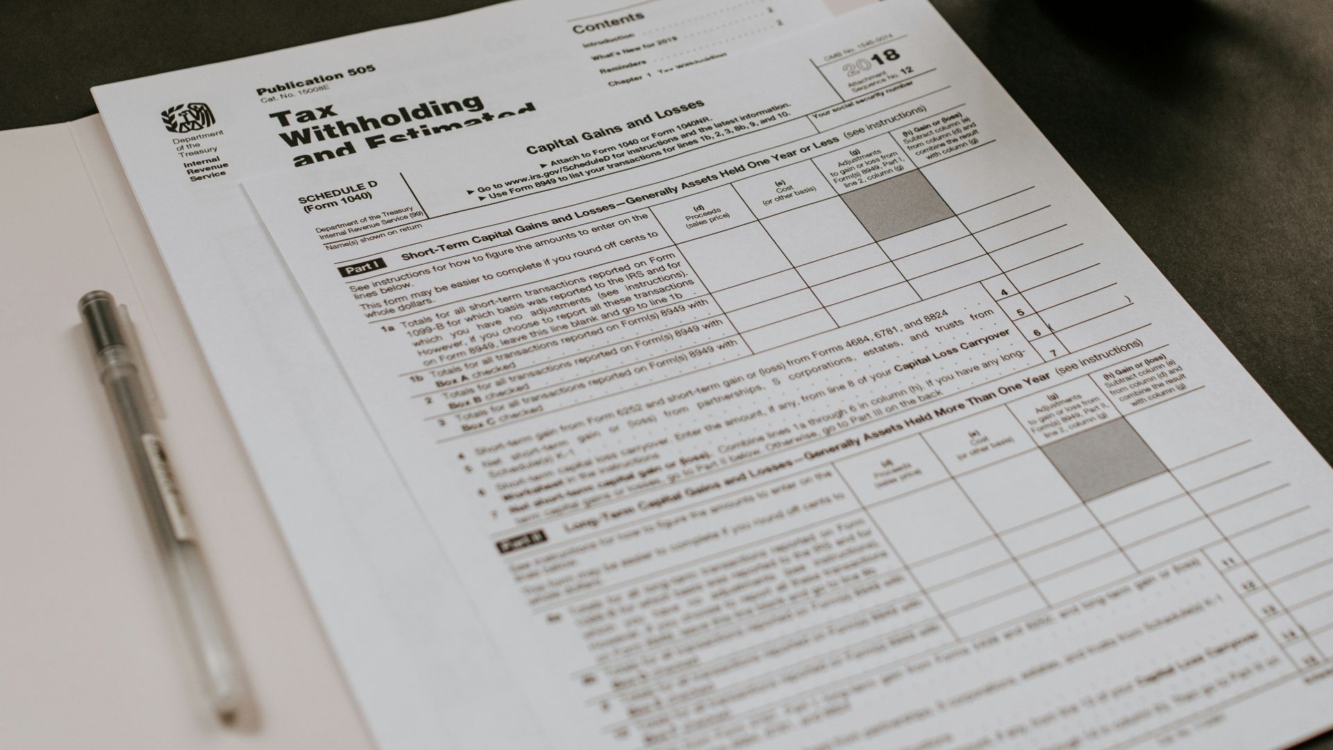 black ceramic mug beside white printer paper