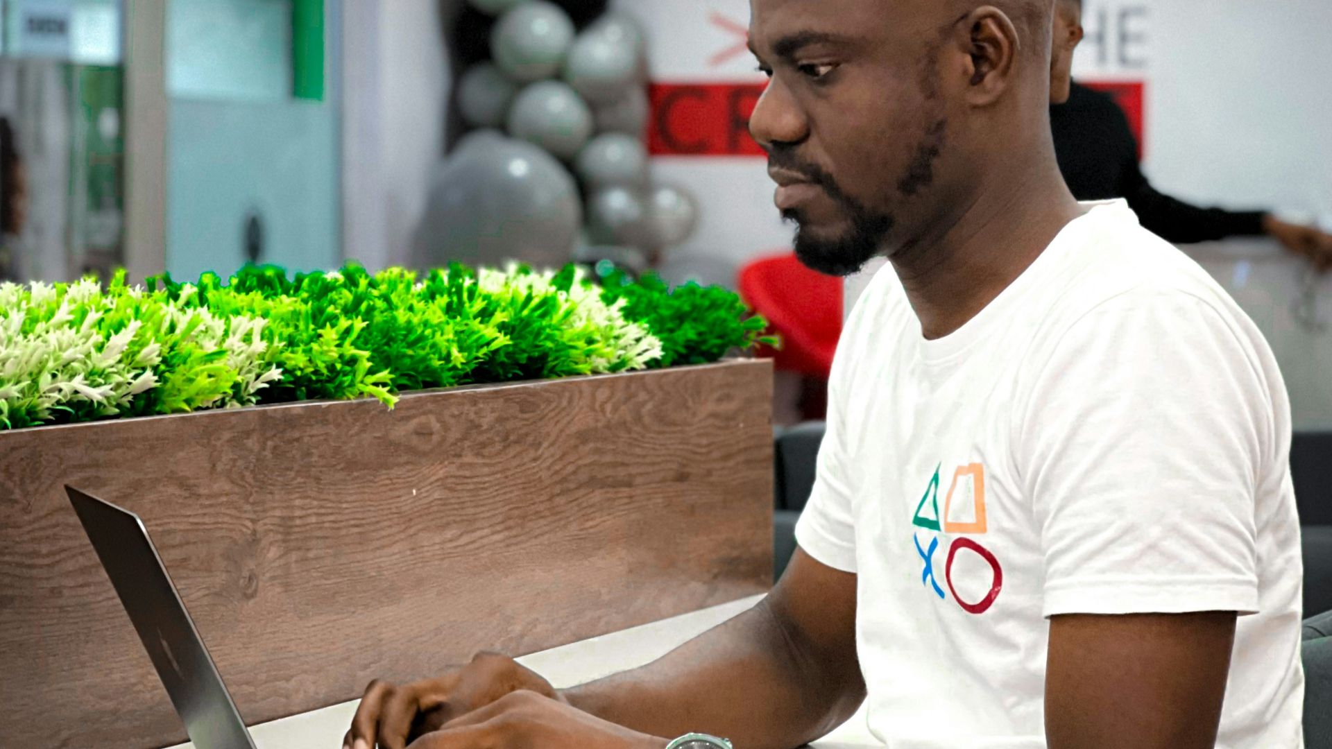 a man sitting at a table using a laptop
