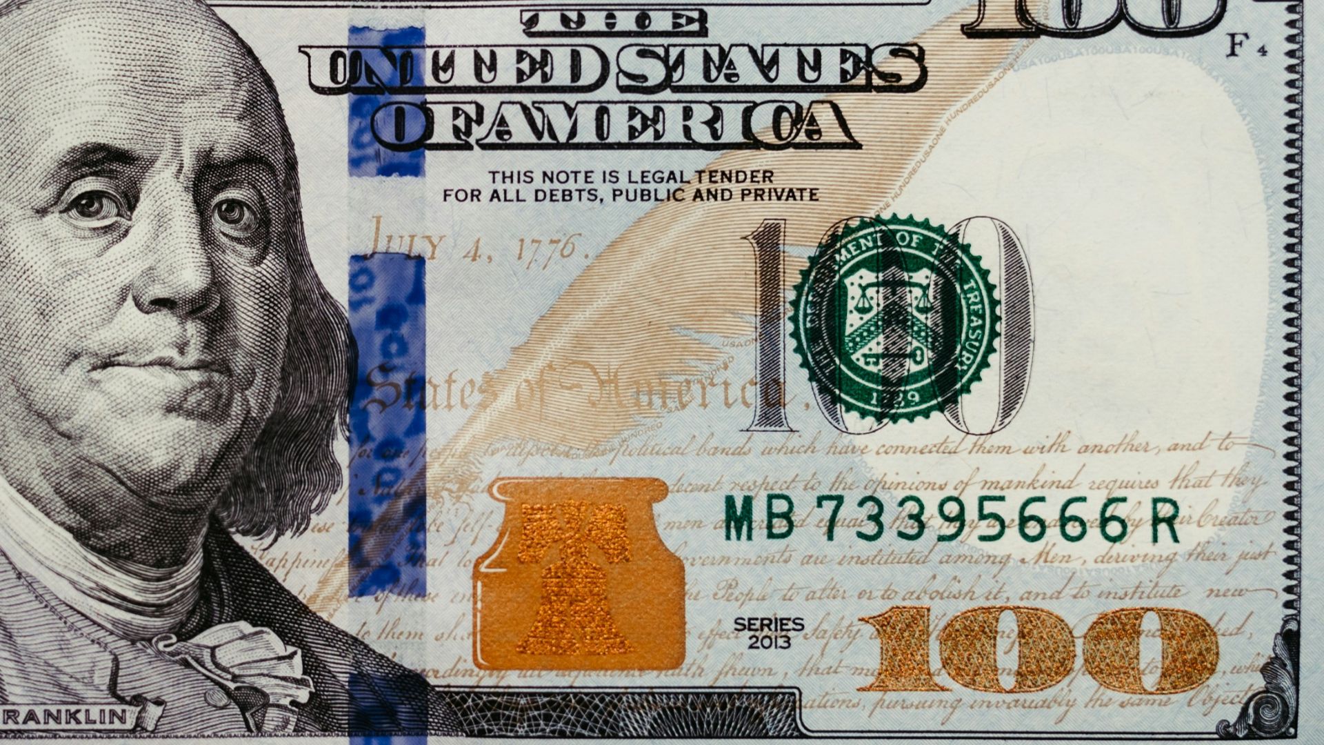 a one hundred dollar bill on a black background