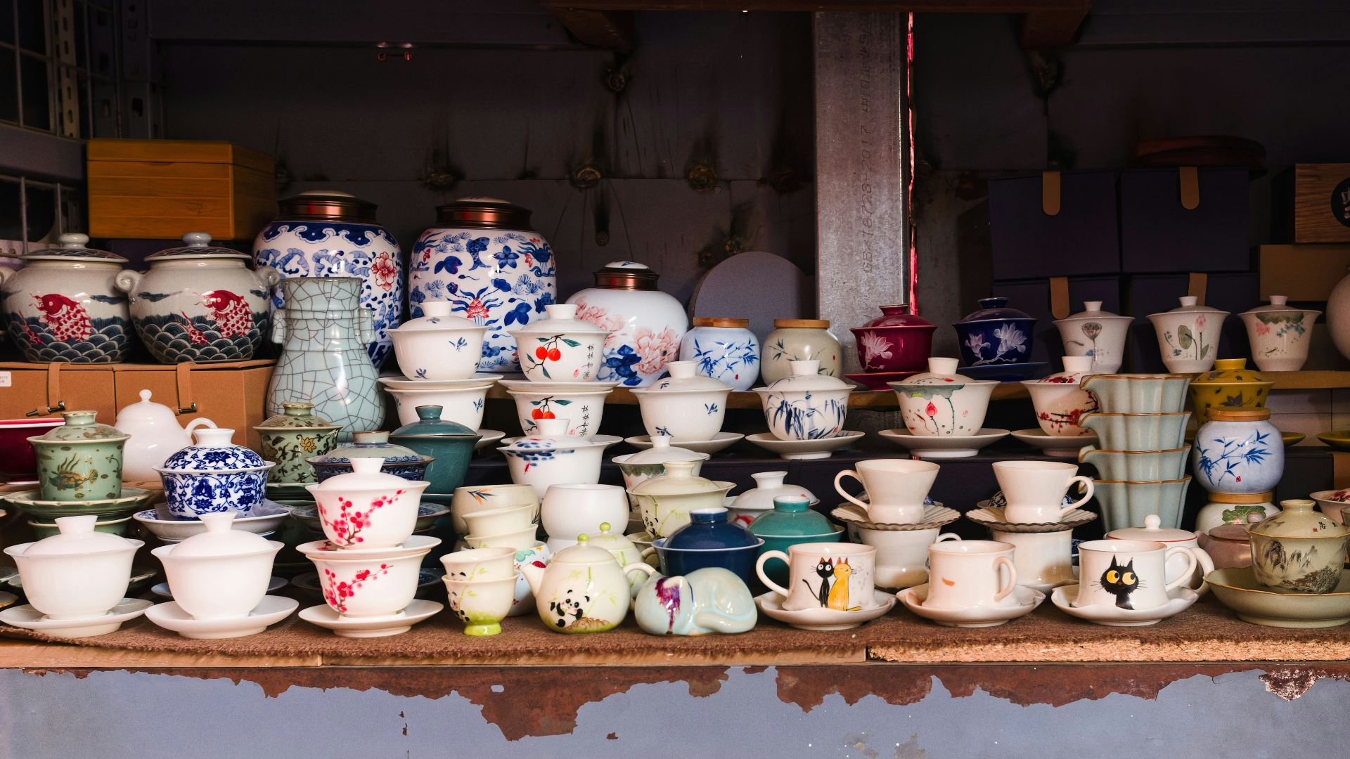 Collection of ceramic teacups and pots on display