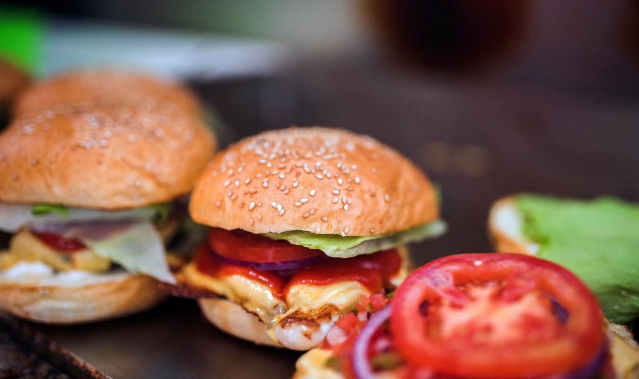 Close-up of tasty cheeseburgers with fresh lettuce and tomato, perfect for food lovers