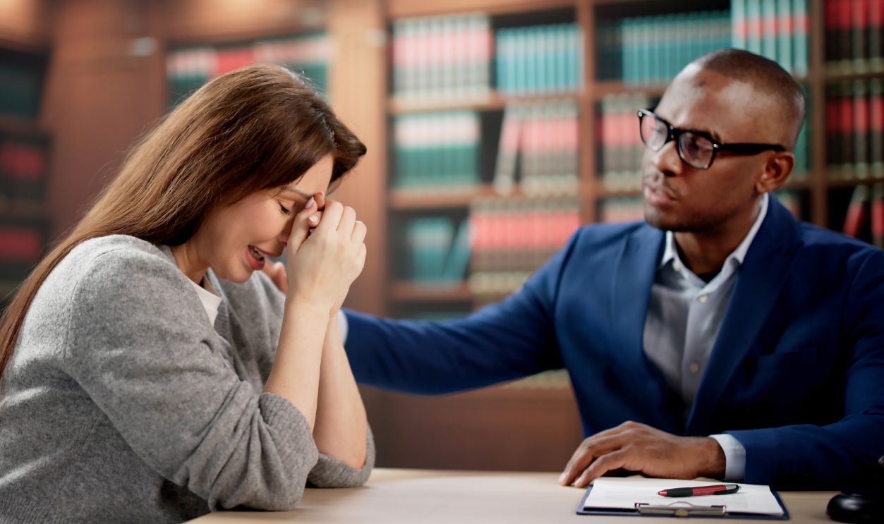 Young Woman Discusses Legal Claim With Attorney During Wrongful Death Consultation Session. Female Client Meets Lawyer