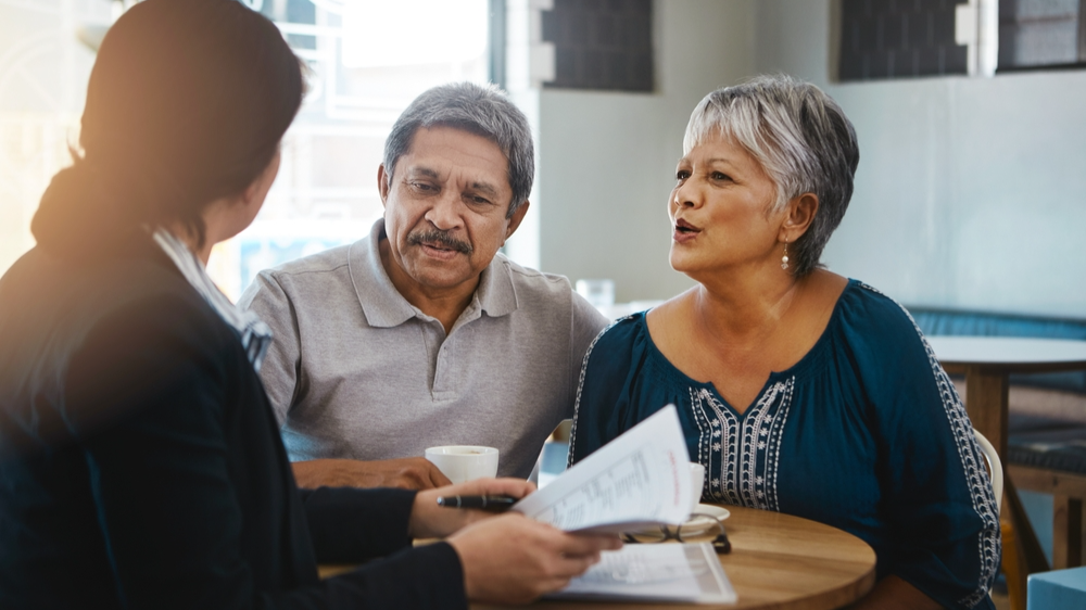 Senior couple, talking and lawyer with documents for financial advice, retirement plan and will at home. Old man, elderly woman and attorney with paperwork, budget negotiation and legal agreement