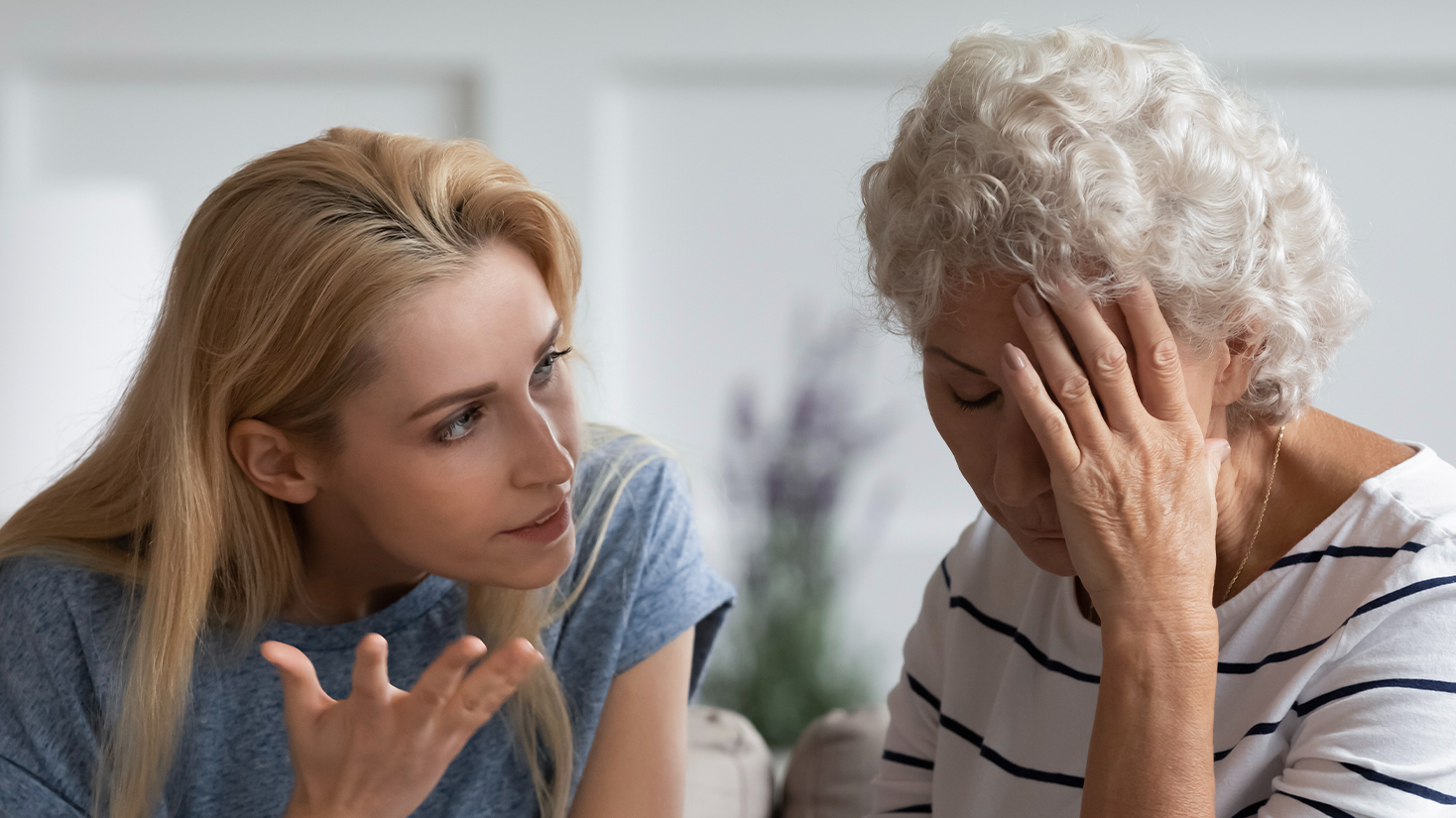 A daughter and elderly mother having an argument.