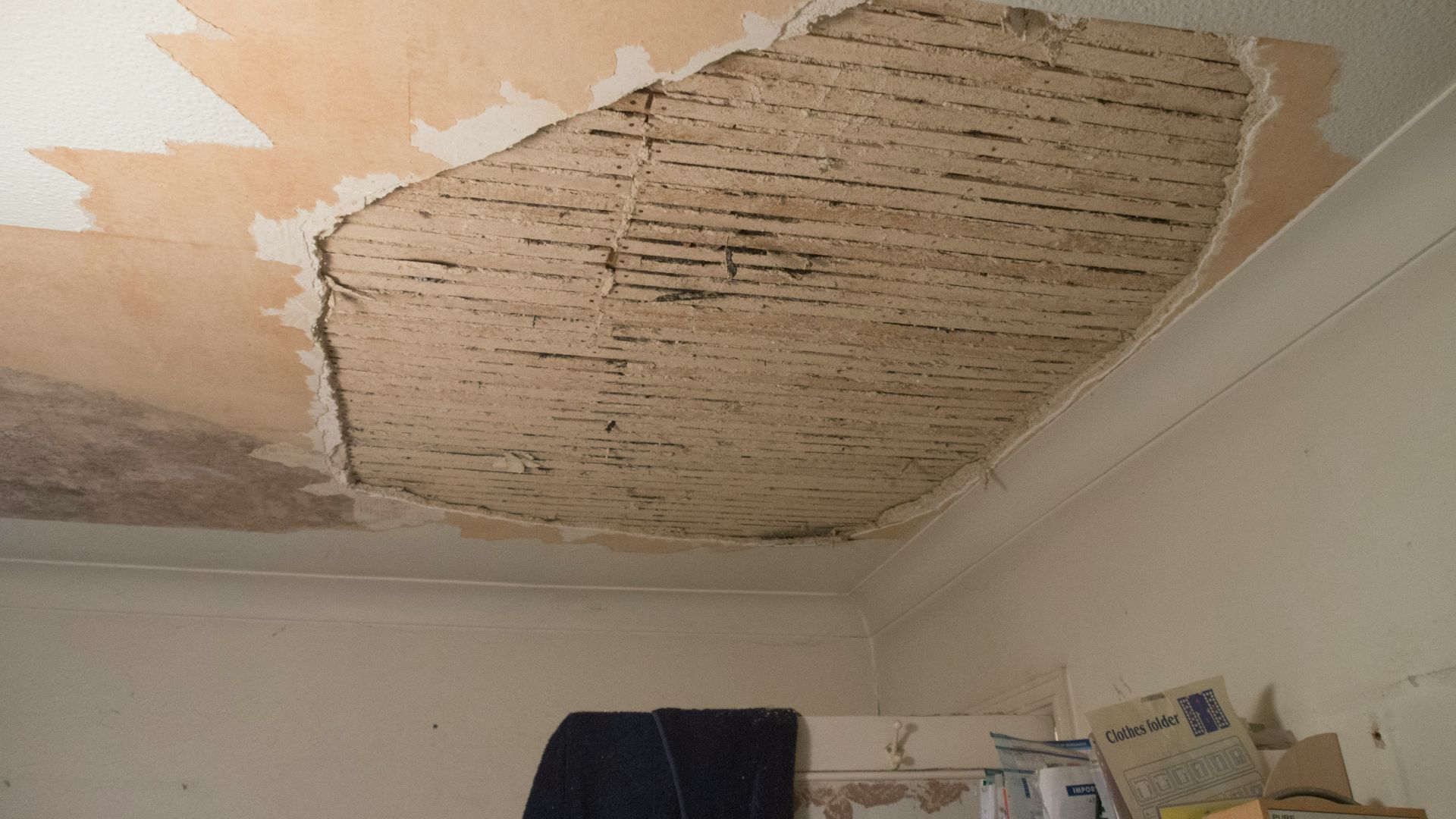 A room with a ceiling that has been torn off