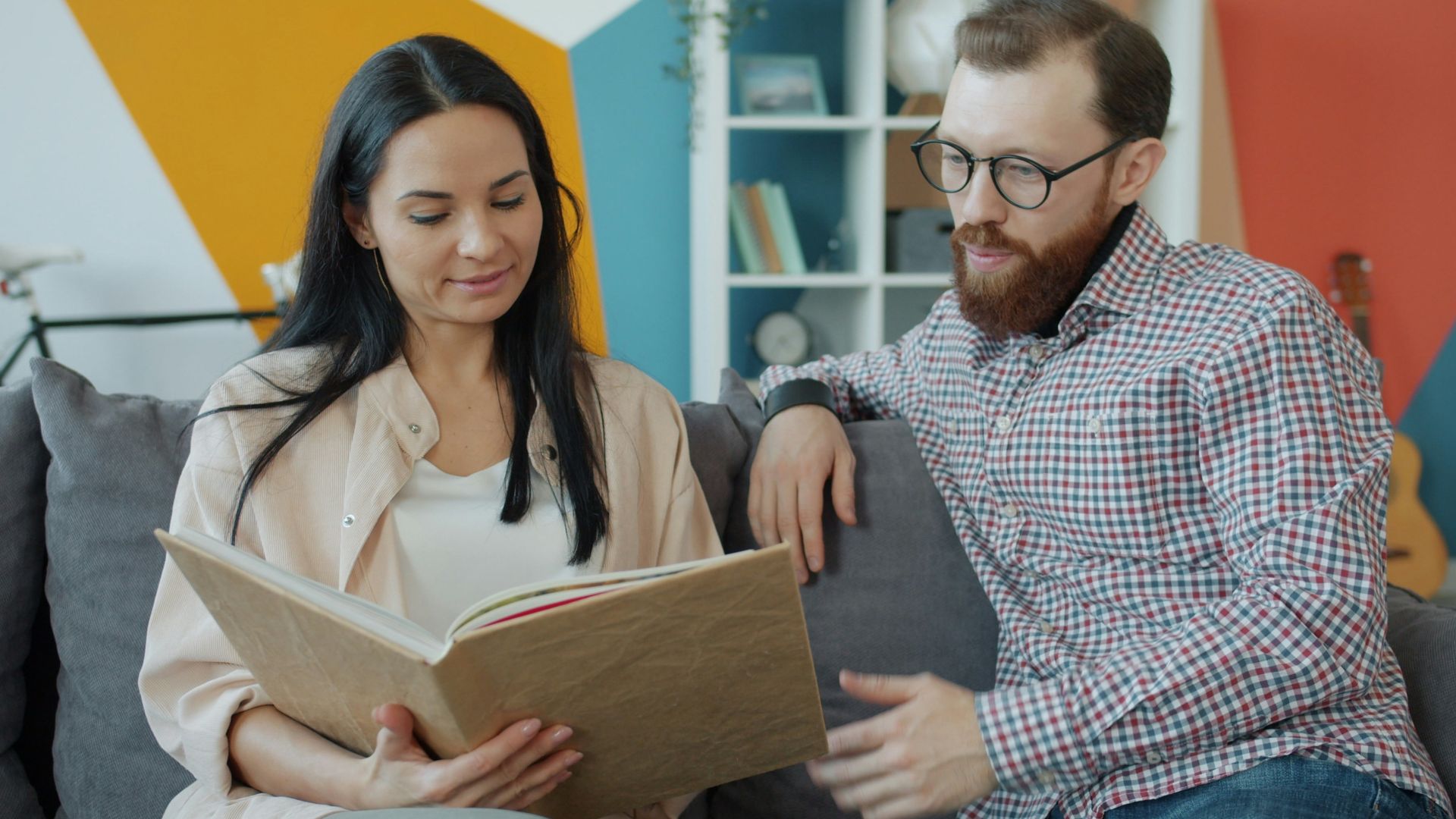 Couple looking at an open photo album together