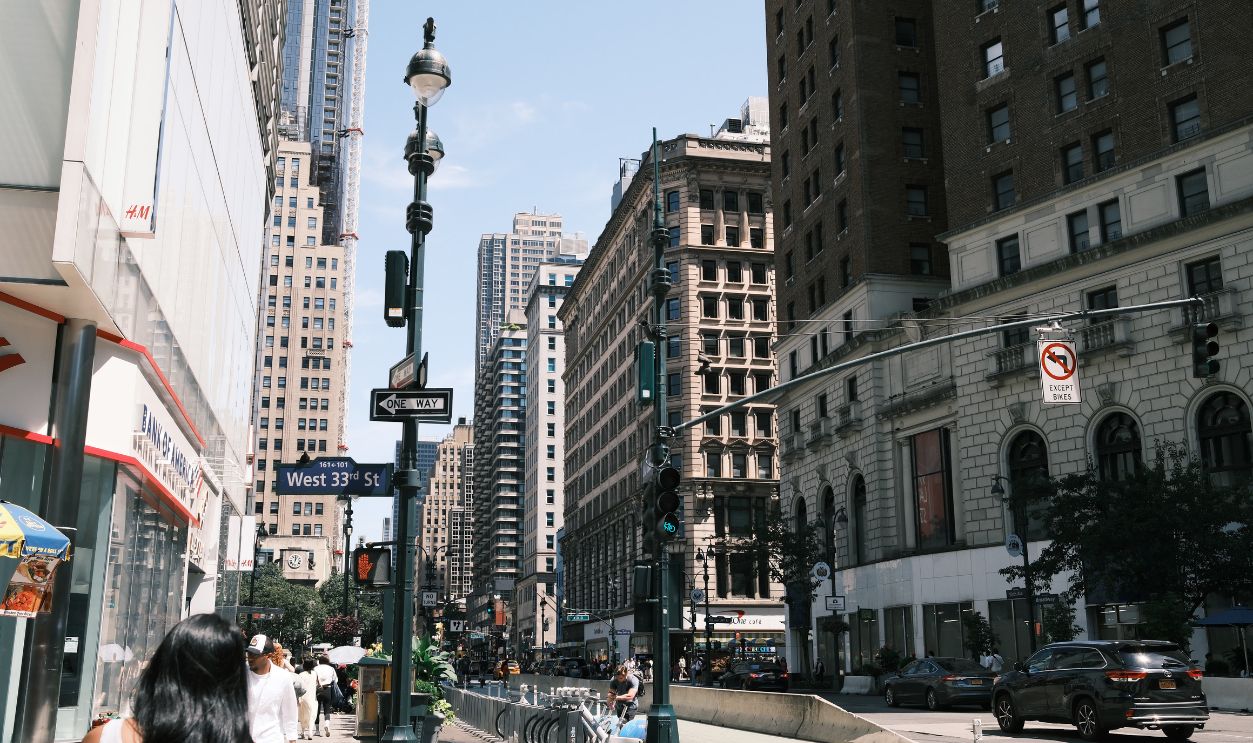 A vibrant view of West 33rd Street in New York City showcasing urban life and architecture