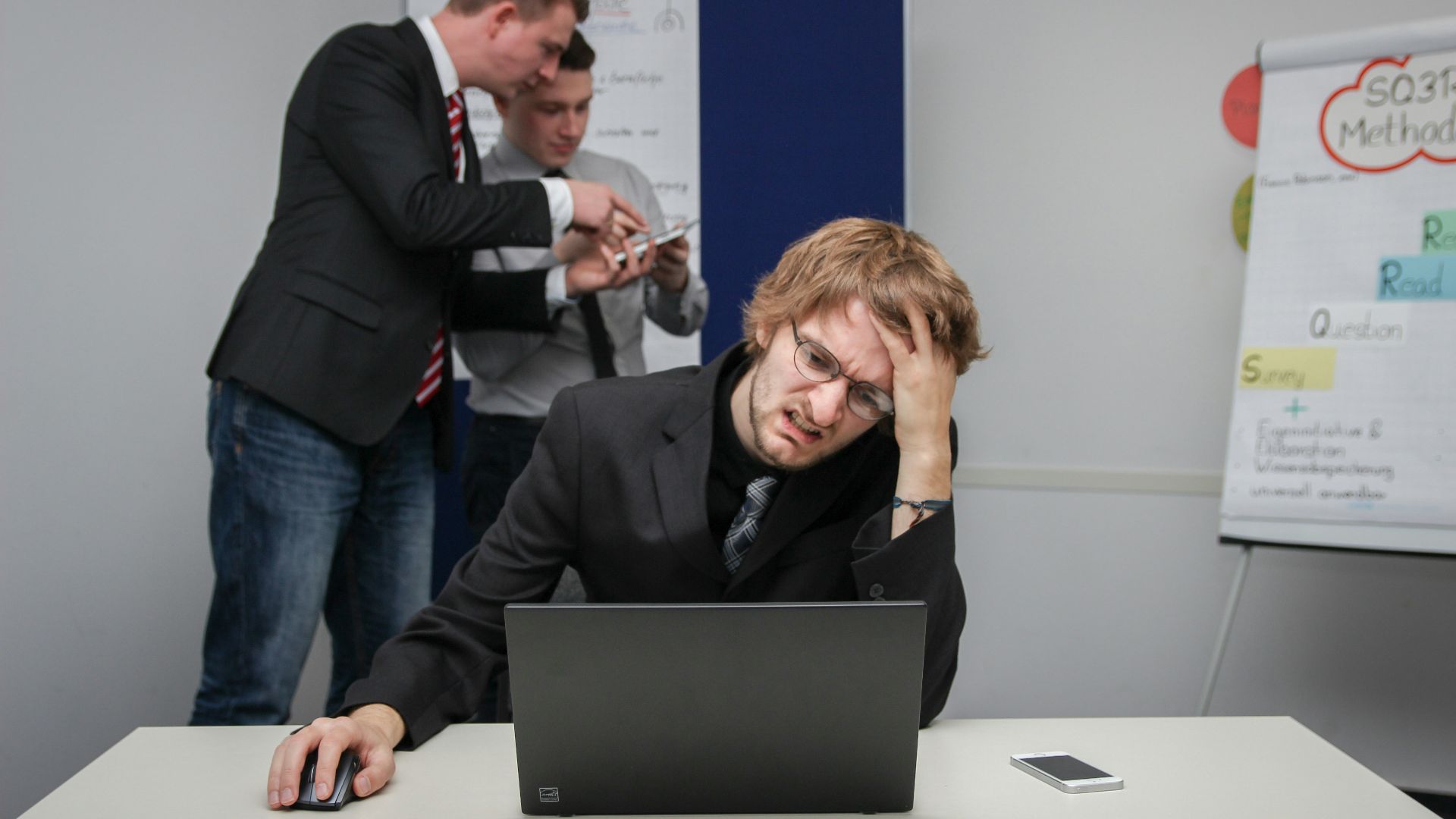 A man sitting in front of a laptop computer