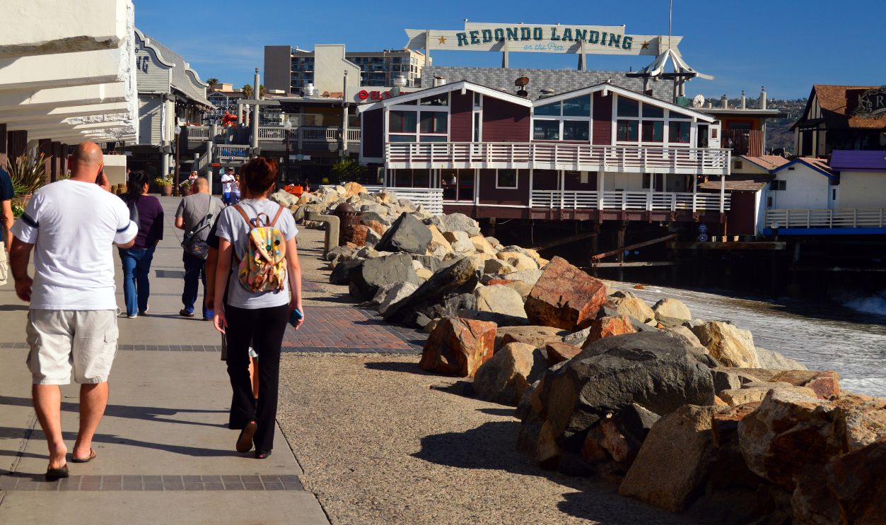 Redondo Beach, CA, USA July 23, People walk along the waterfront footpath leading to the pier at Redondo Beach, California