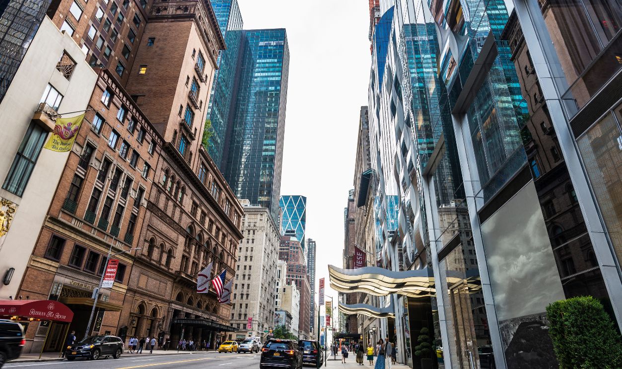 New York City, USA - July 28, 2018: 57 Street with its modern skyscrapers and people around in Manhattan, New York City, USA