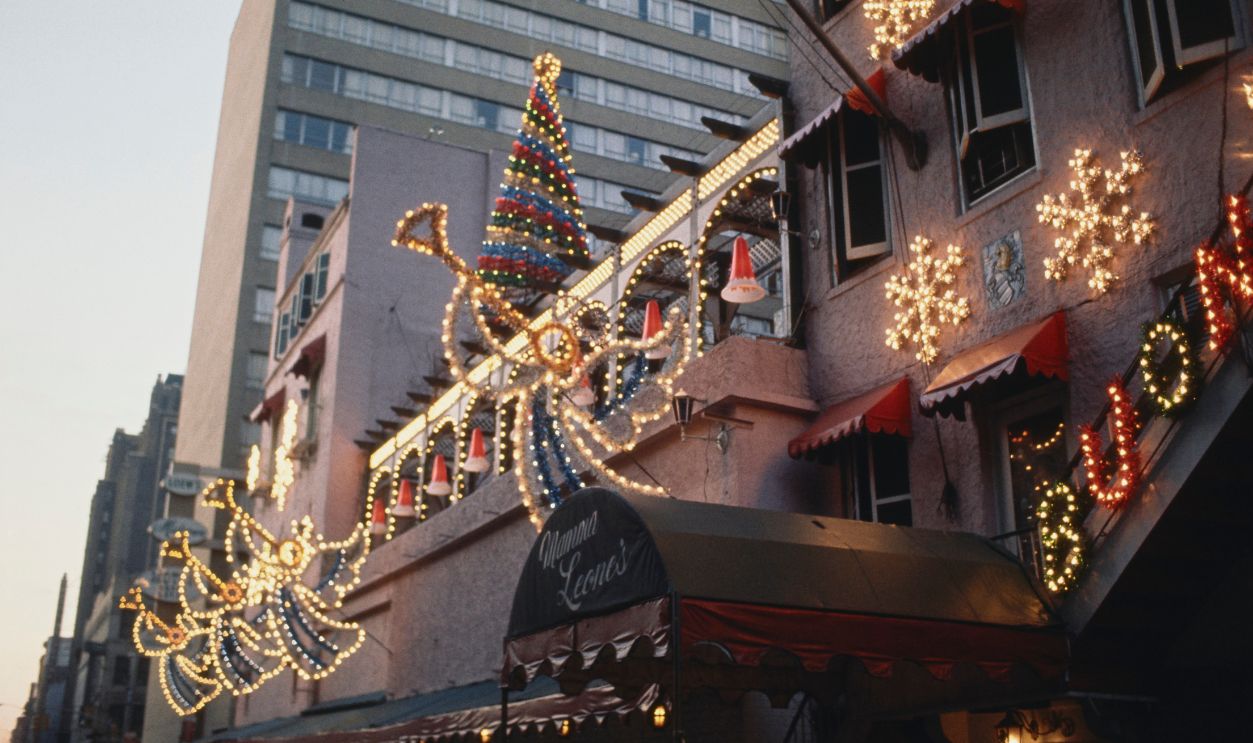 The exterior of Mamma Leone's Italian restaurant covered in lights and Christmas decorations, New York, December 1969.