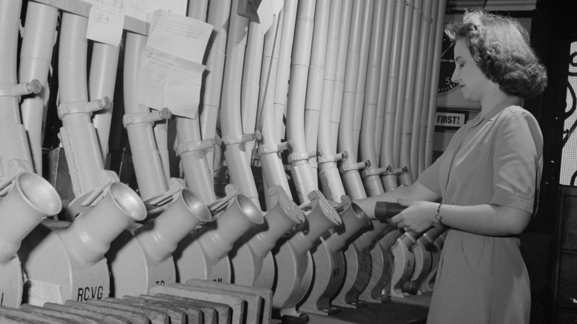 Washington, D.C. Miss Helen Ringwald works with the pneumatic tubes through which messages are sent to branches in other parts of the city for delivery