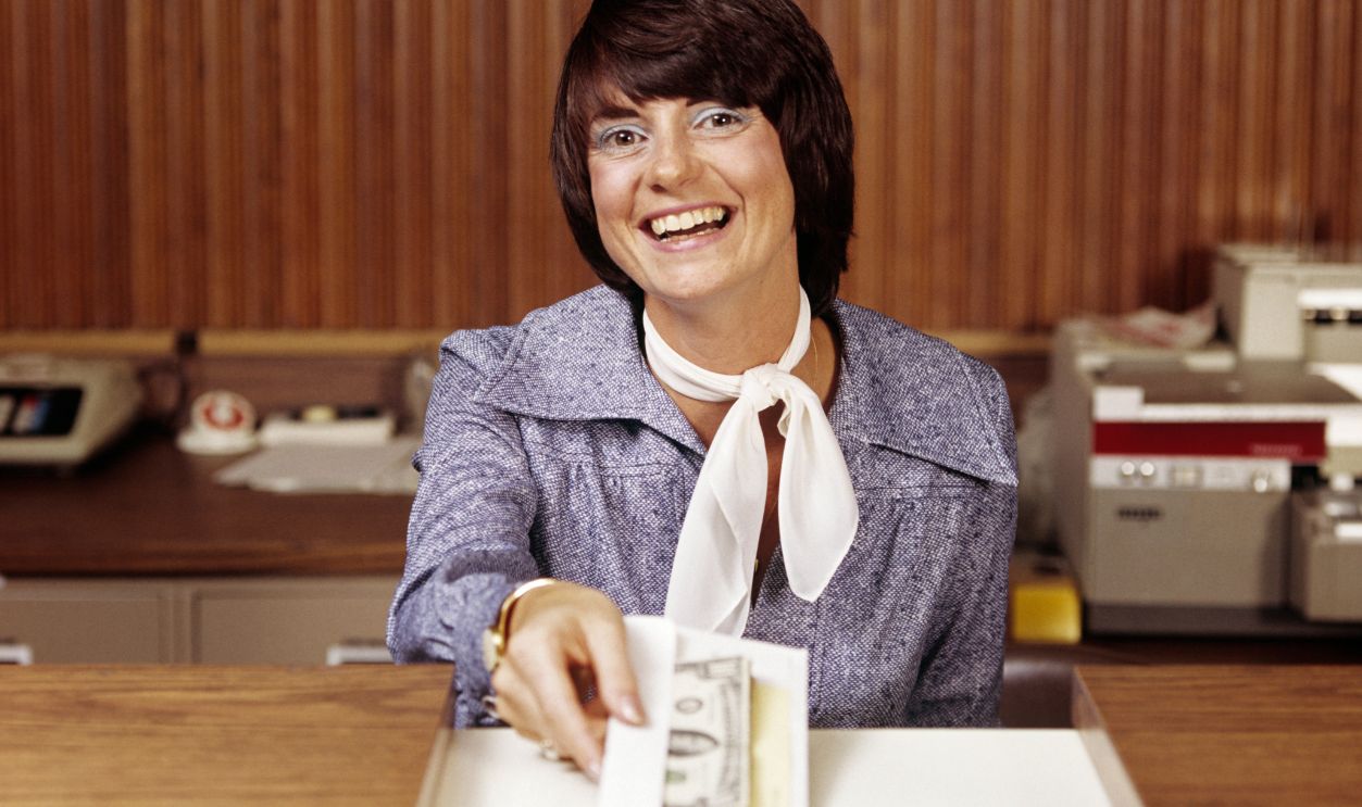 1970s SMILING WOMAN BANK...