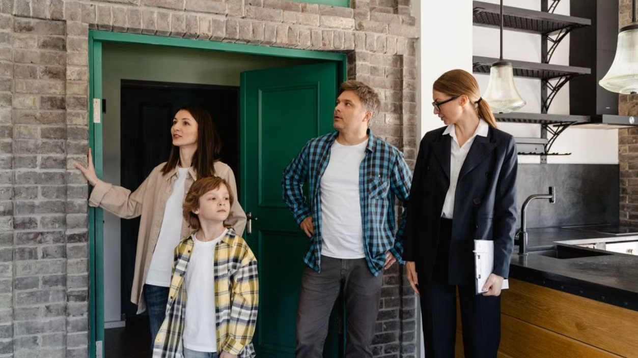 Family exploring potential new home guided by a real estate agent