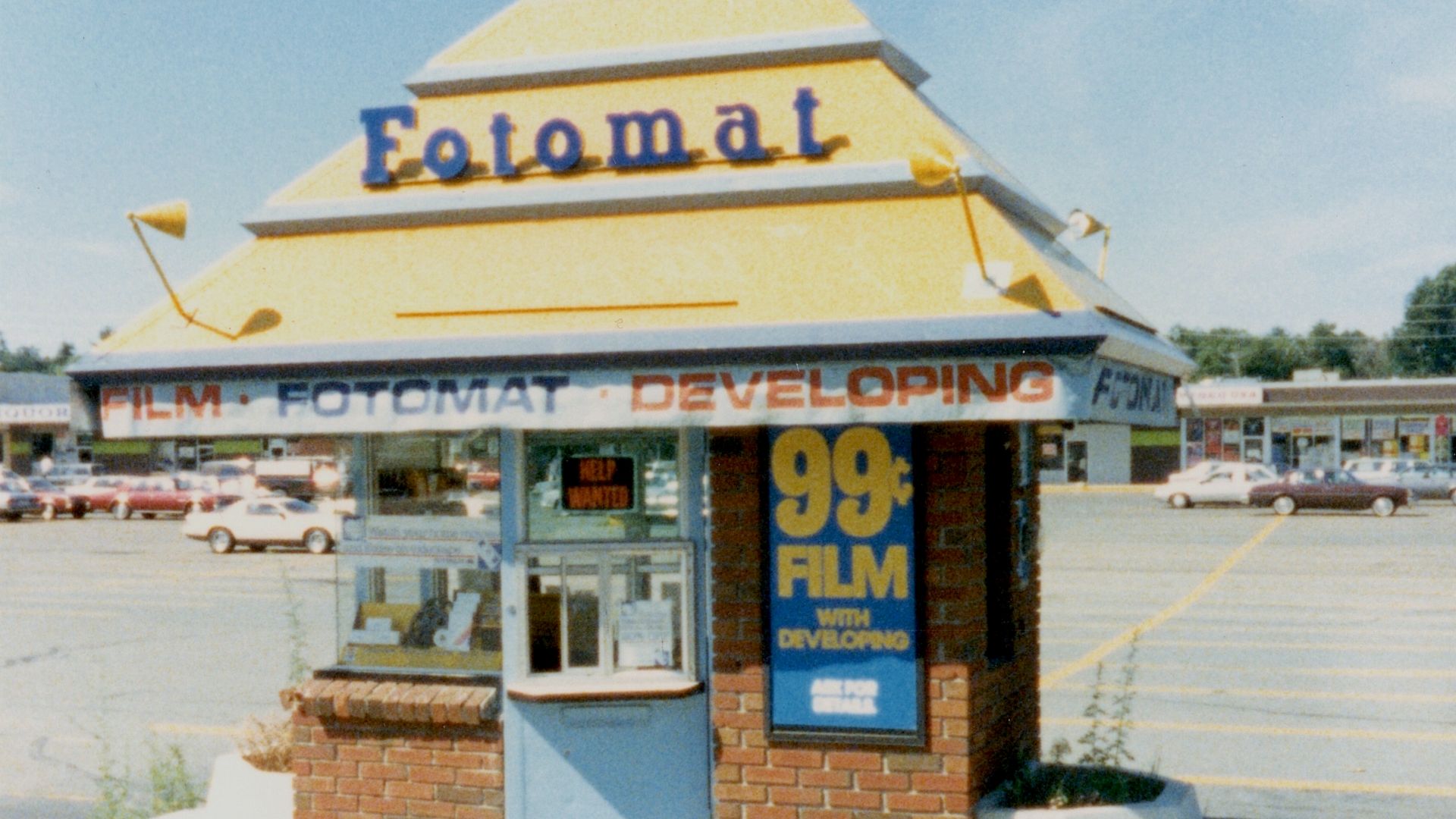 This is a typical drive-up Fotomat booth.  Photographed in 1987, this one was located in West Peabody, Massachusetts, in a shopping center on Russell Street.