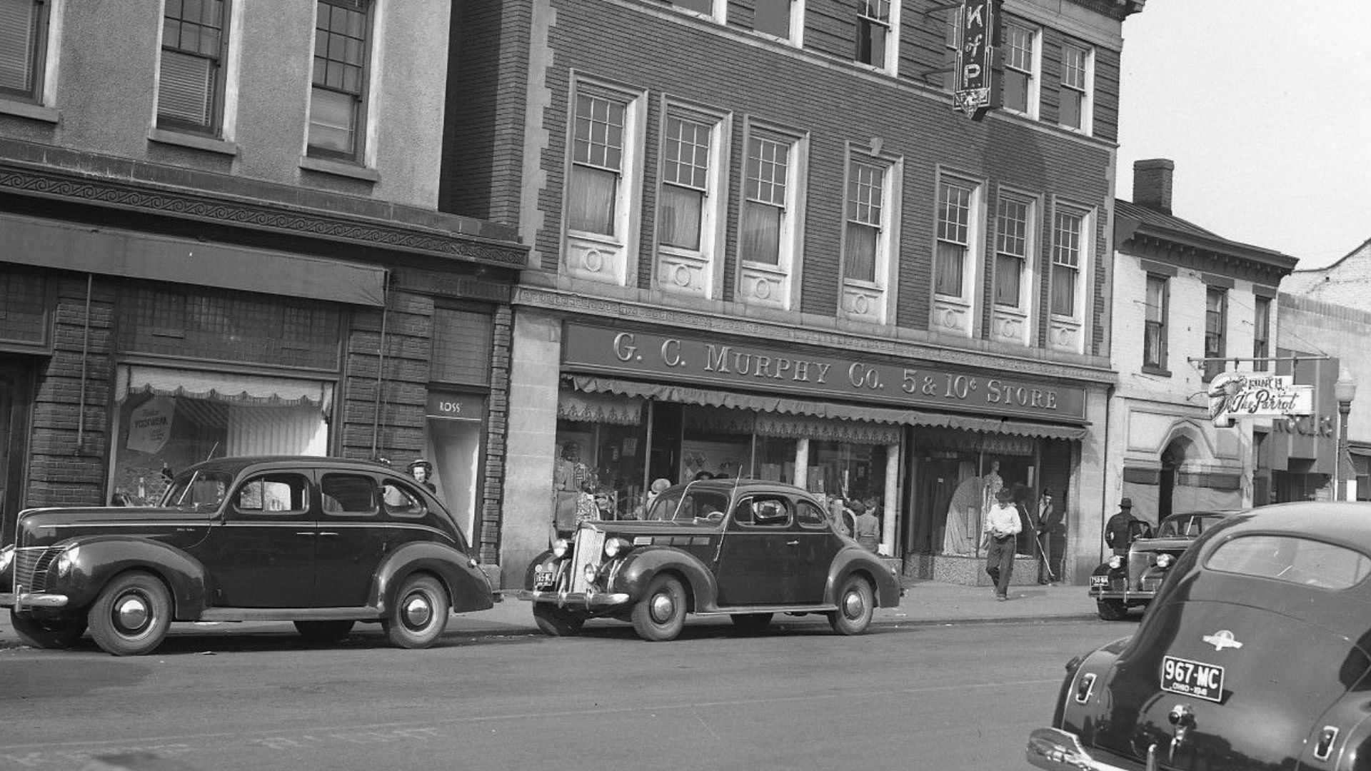 Three photographs of the C. G. Murphy Company located in the Knights of Pythias Building, 1046 Central Avenue, Middletown, Ohio. Photographs are dated 1941. Third photograph is wide shot Central Avenue looking east. G. C. Murphy Company was a chain of var