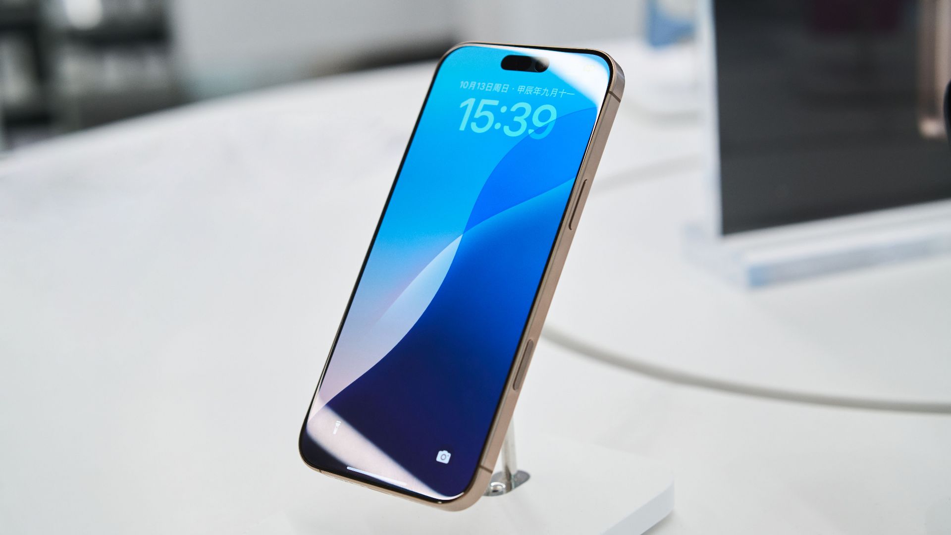Modern smartphone showcased in a tech store setting, highlighting its sleek design.