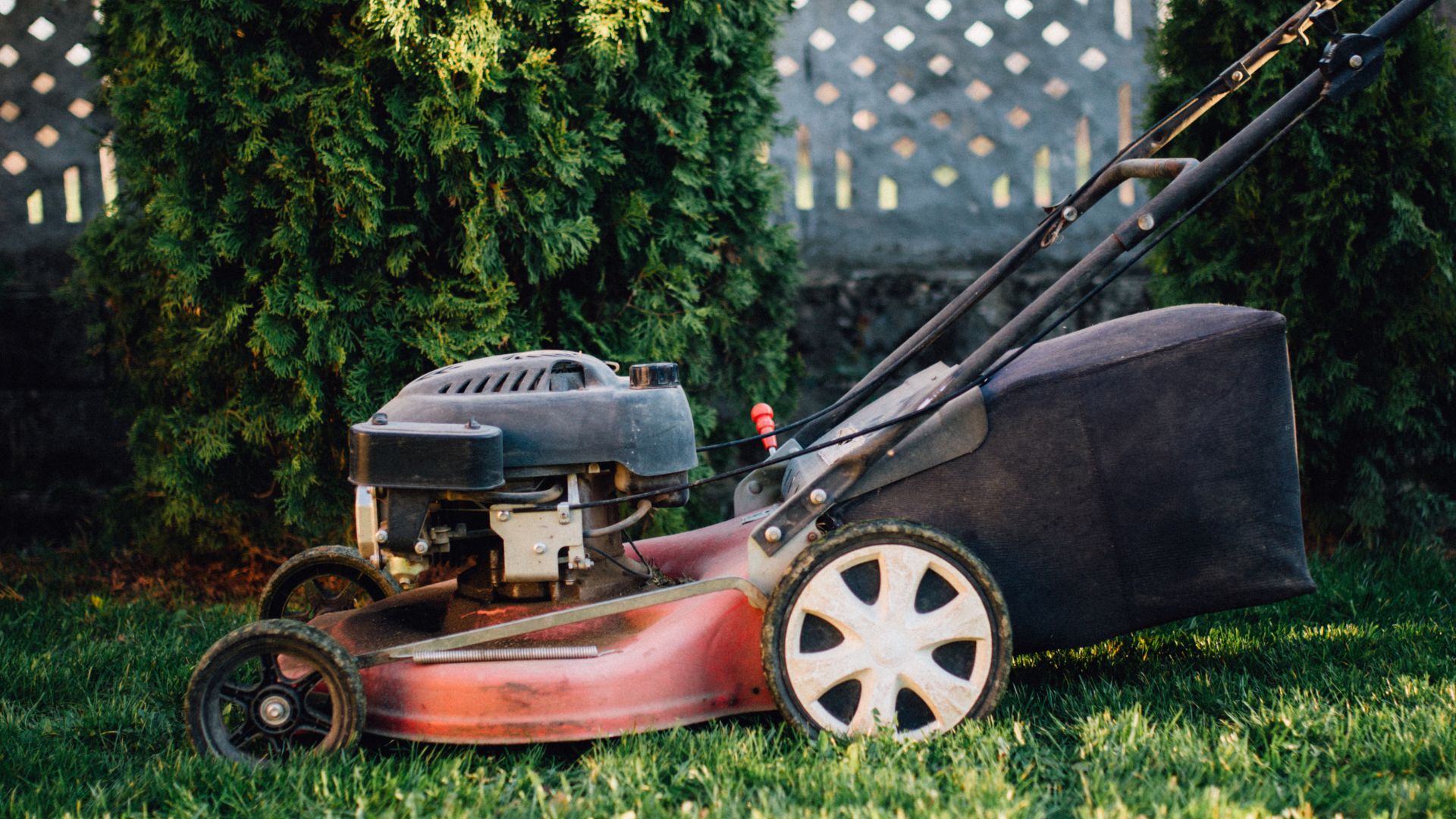 Vintage lawn mower motor engine on grass