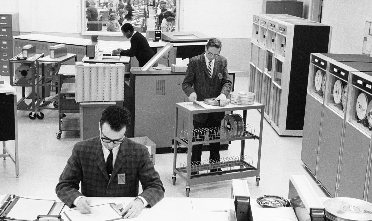 View of employees in the computer room of a regional IRS office, Philadelphia, Pennsylvania, March 11, 1965.